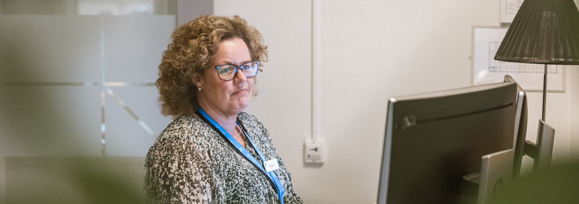 Medarbetare står vid dator